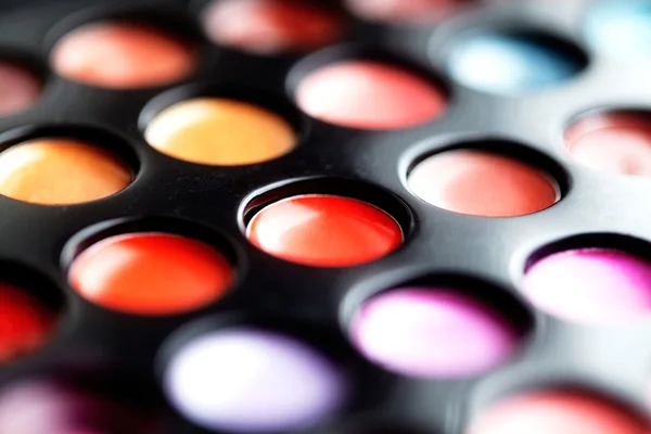 Close-up macro shot of lipgloss palette. Colourful salon cosmetics for makeup artist. Vibrant make-up product. Soft focus