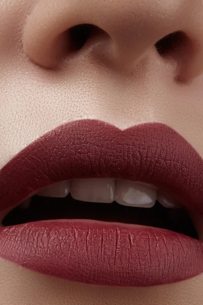 Close-up of woman\'s lips with fashion red make-up. Beautiful female mouth, full lips with perfect makeup. Classic visage. Part of female face. Macro shot of beautiful make up on full lips