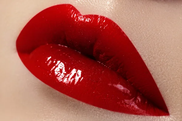 Close-up of female lips with bright makeup. Macro of woman\'s face. Fashion lip make-up with red gloss. Horizontal shoot