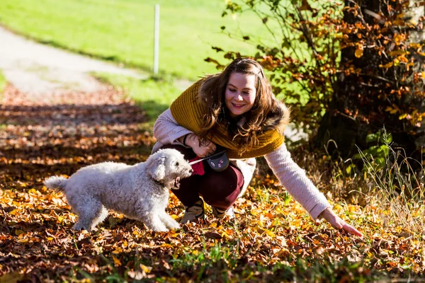 Girl with a poodle in forest