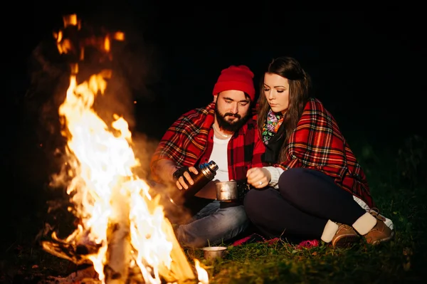 Lovers around the campfire at night