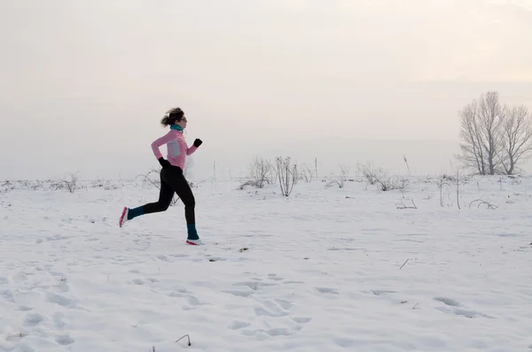 Woman running on the snow