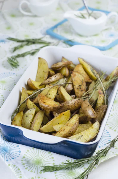 Slices of baked potatoes with rosemary