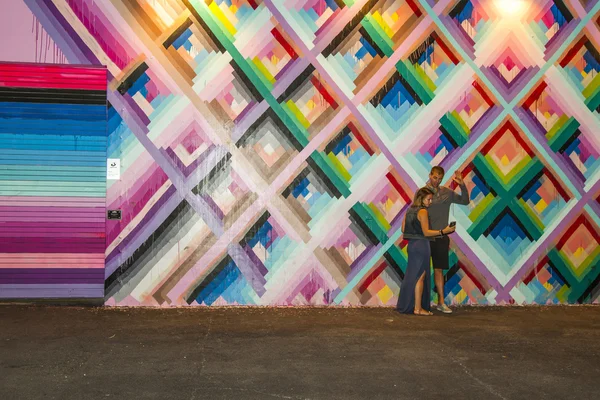 Couple taking a selfie with art murals at Wynwood arts district