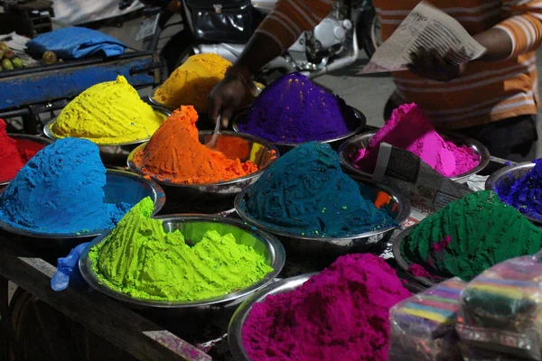 Indian colorful powders for Holi celebration at market in India. Puttaparthi, South India.
