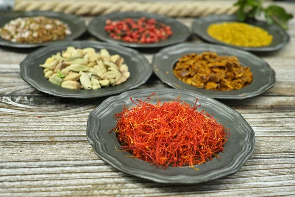 Red saffron and spices and herbs in metal bowls. Food and cuisin