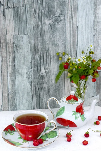 Fresh wild strawberry tea and bouquet of ripe wild strawberries