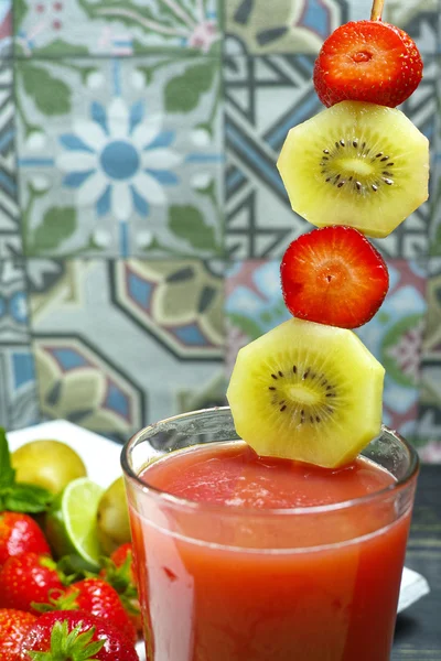 Fresh pressed strawberry and gold kiwi juice in a glass
