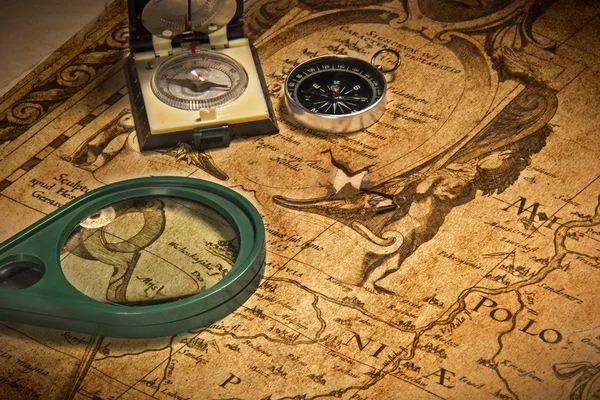 Old, Vintage map and compass, magnifer.Background