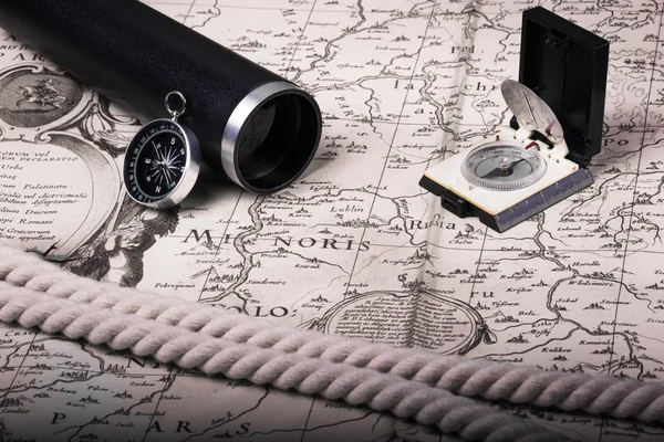 Compas, spyglass, rope on the old map.Sail theme. background.