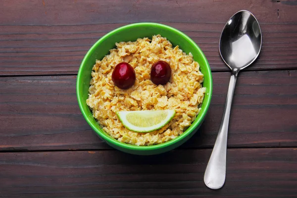 Oatmeal smiling (smile) concept.Eyes merry, mouth lime.Flat lay.