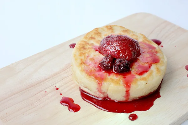 English Crumpets & Berry Topping on wood board isolate on white background