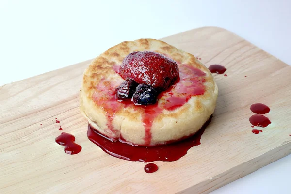 English Crumpets & Berry Topping on wood board isolate on white background