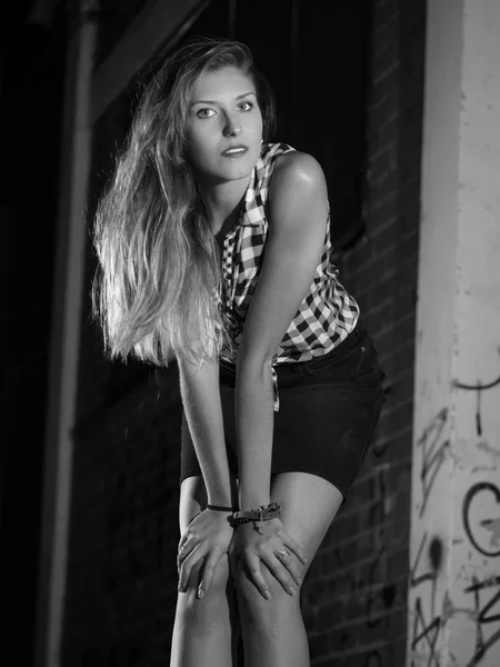 Black and white pretty blonde woman leaning on her knees