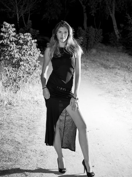 Black and white sexy blonde woman full-length evening in nature