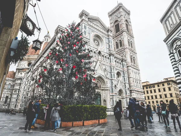 Italy tourists next to Florence Cathedral and Christmas tree