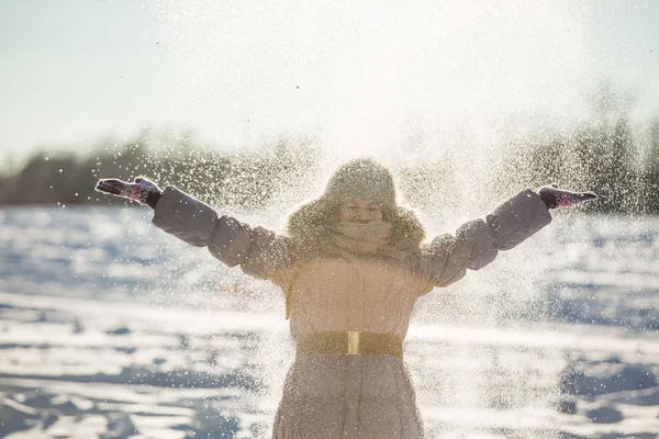 Girl throws snow up