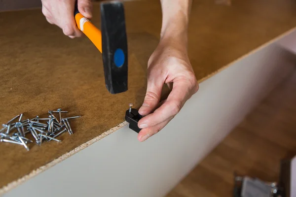 Man hammers a nail