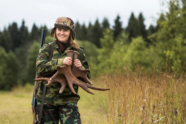 Hunter holds moose antlers