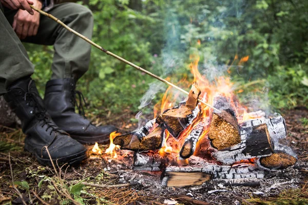 Man roating bread on fire