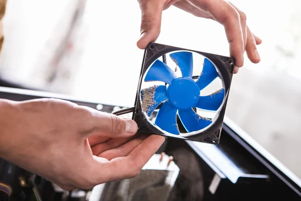 Man holding computer fan