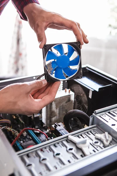 Man holding computer fan