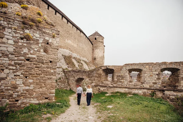 Young couple have fun near the medieval castle