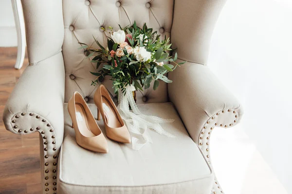 Bridal bouquet of peones with white shoes