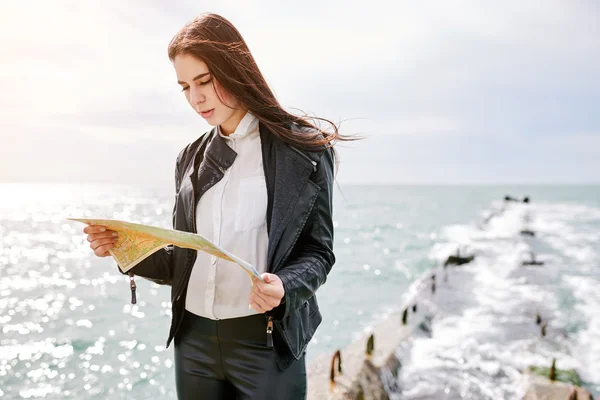 Woman on the pier watching map