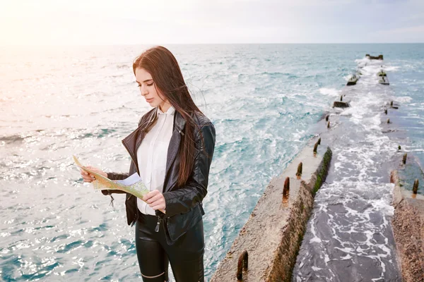 Woman on the pier watching map