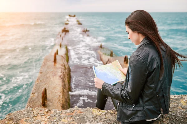 Woman on the pier watching map