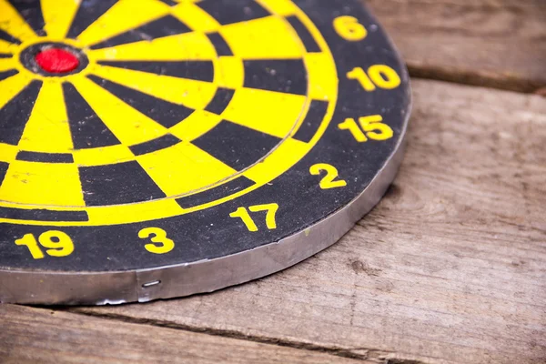 Darts dartboards, on a brown wooden Board. Table for the game of Darts. the success failure of the business concept. Closeup. place for text