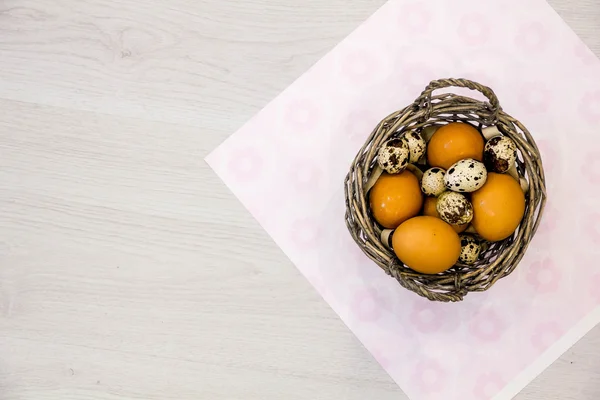 Plate with quail eggs and chicken eggs. Quail eggs in a wooden bowl. place for text. nutrition protein diet. Top view, flat lay with copyspace for slogan or text message. colorful background