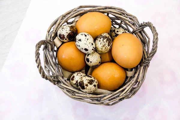 Plate with quail eggs and chicken eggs. Quail eggs in a wooden bowl. place for text. nutrition protein diet. Top view, flat lay with copyspace for slogan or text message. colorful background