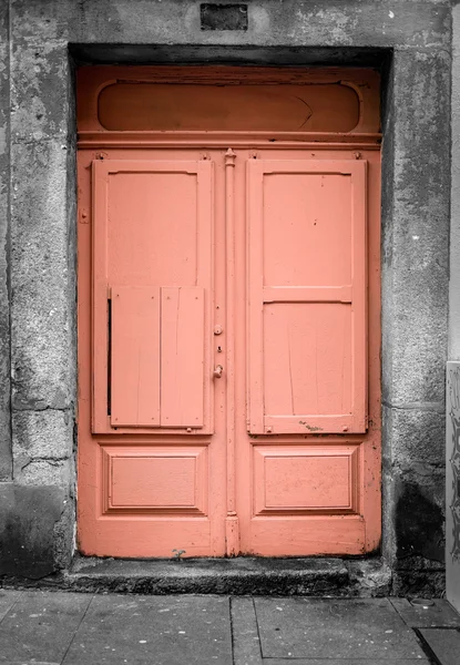 Orange door at the black and white background