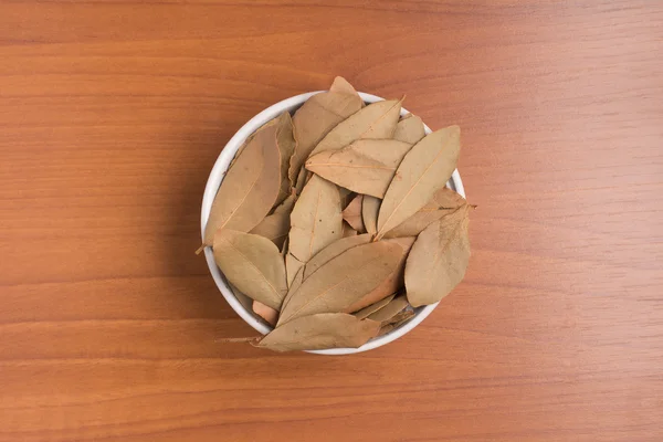 Bulk Bay Leaves into a bowl. (Laurus nobilis)
