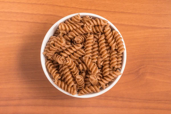 Wholemeal Fusilli into a bowl. Integral Pasta