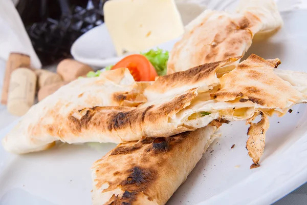 Roasted rolls of bread lavash filled with cheese