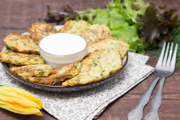 Squash and zucchini fritters with flowers zucchini and herbs
