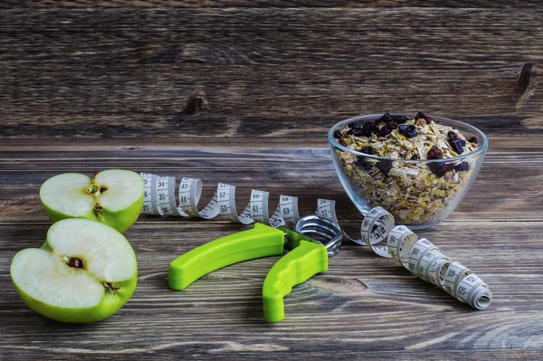 The concept of a healthy lifestyle. Green apples, oatmeal with r
