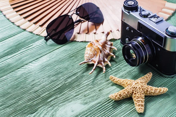 Summer travel vintage camera and and sunglasses, shell and starf