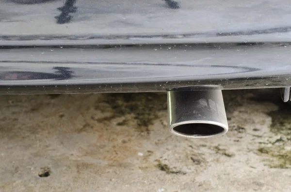 Exhaust pipe of car on cement background