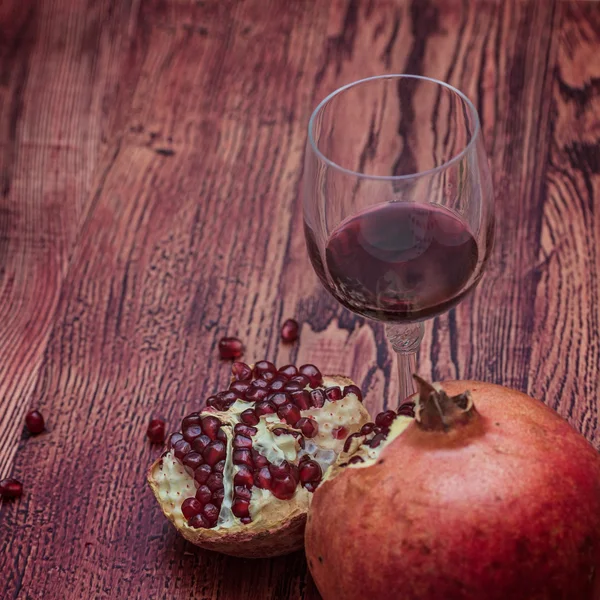 Pomegranate and a glass of red wine. Dinner time.