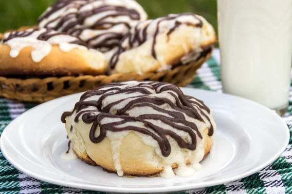 Homemade cinnabon cinnamon buns with cream cheese glaze and chocolate icing