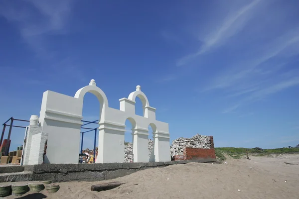 Arch door shape architecture leave at beach of Shimen District