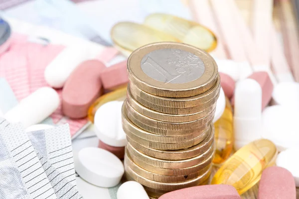 Close up of a stack of money with capsules in the background