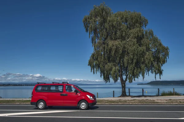 Taupo, New Zealand - March 2 2015: Lake Taupo in North Island of New Zealand with a red van driving pass