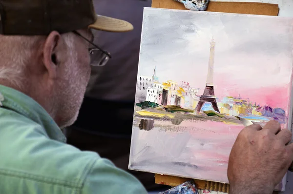 PARIS, FRANCE - APRIL 20, 2015: An artist drawing at Place du Tertre, an open-air workshop with its 288 official painters on Montmartre