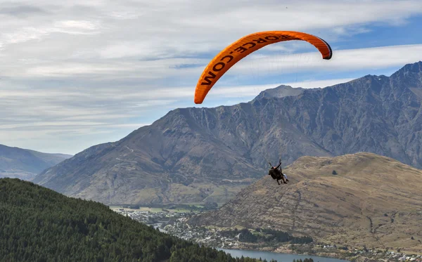 Queenstown, New Zealand - March 2016: Tandem paragliding over Lake Wakatipu in Queenstown, New Zealand