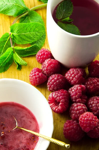Tea and raspberry jam, mint and fresh raspberries